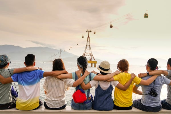 Group of friends with arms around each other — community and relationships