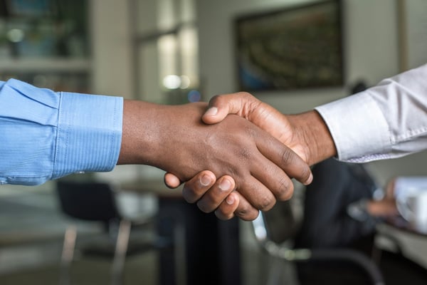 Two people shaking hands — trust and honesty